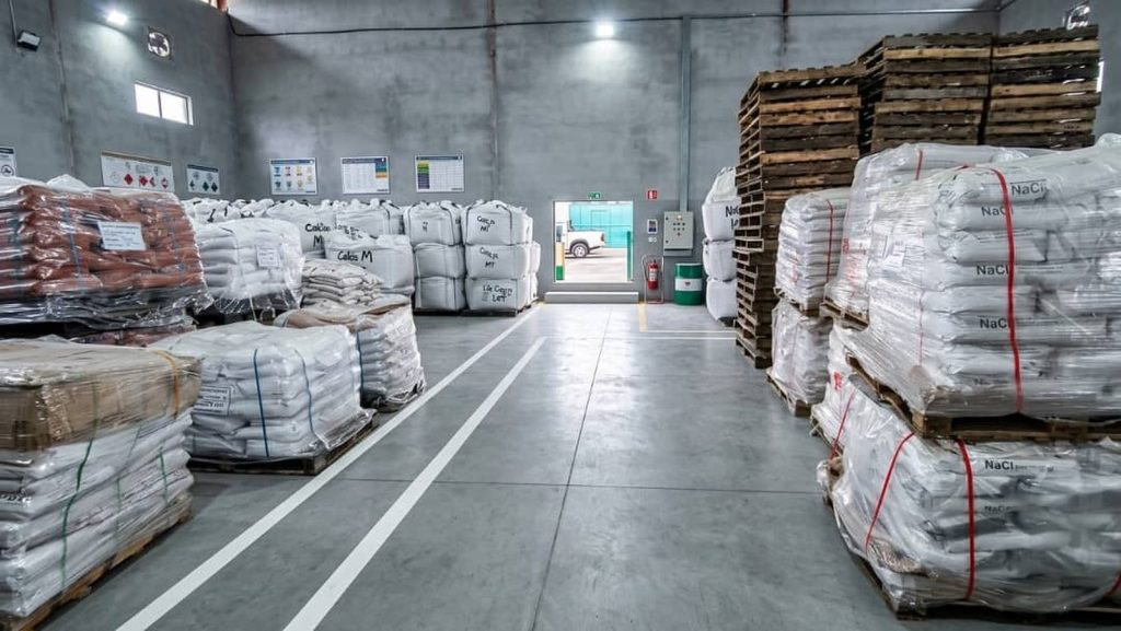 Warehouse with pallets of sodium chloride (NaCl) sacks